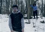 Ahamus in film dressed in a trashbag in the showy woods