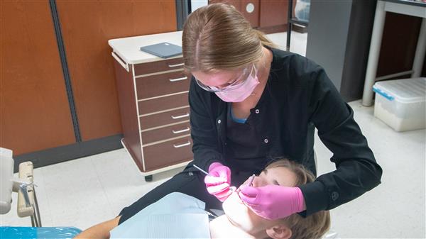 Dental Occupations student working on Patient