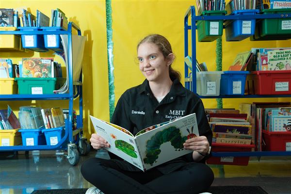 Early Childhood Education student reading a book